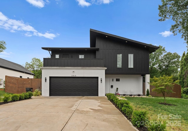 2913 Lake Ave, Charlotte, NC 28208 - modern home featuring a balcony, concrete driveway, an attached garage, board and batten siding, and brick siding