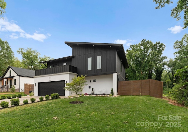 2913 Lake Ave, Charlotte, NC 28208 - view of front of home with board and batten siding, a balcony, a garage, and driveway