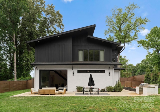 2913 Lake Ave, Charlotte, NC 28208 - rear view of house with a patio, outdoor lounge area, and brick siding