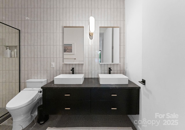 2913 Lake Ave, Charlotte, NC 28208 - full bathroom featuring tile walls, tile patterned flooring, toilet, double vanity, and tasteful backsplash