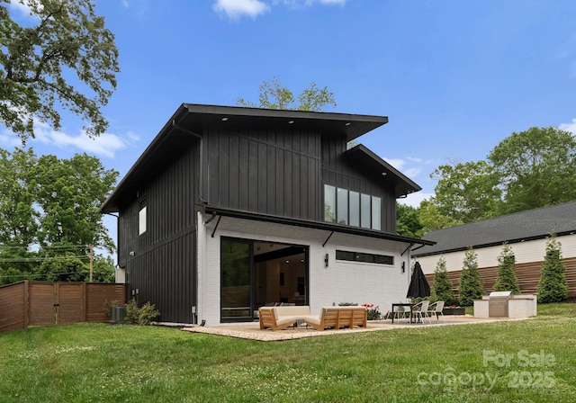 2913 Lake Ave, Charlotte, NC 28208 - back of house featuring a patio, board and batten siding, a gate, central air condition unit, and an outdoor hangout area