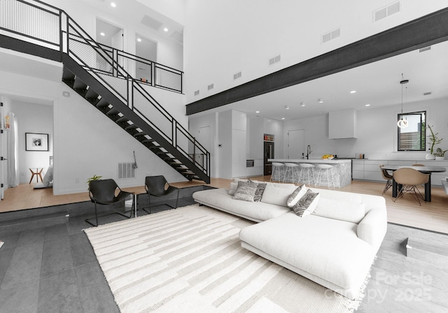 2913 Lake Ave, Charlotte, NC 28208 - living area featuring a towering ceiling, stairway, and recessed lighting