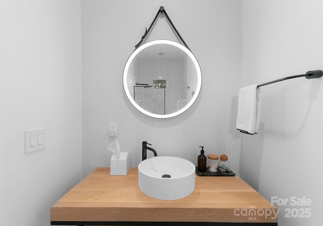 2913 Lake Ave, Charlotte, NC 28208 - bathroom with wallpapered walls and vanity