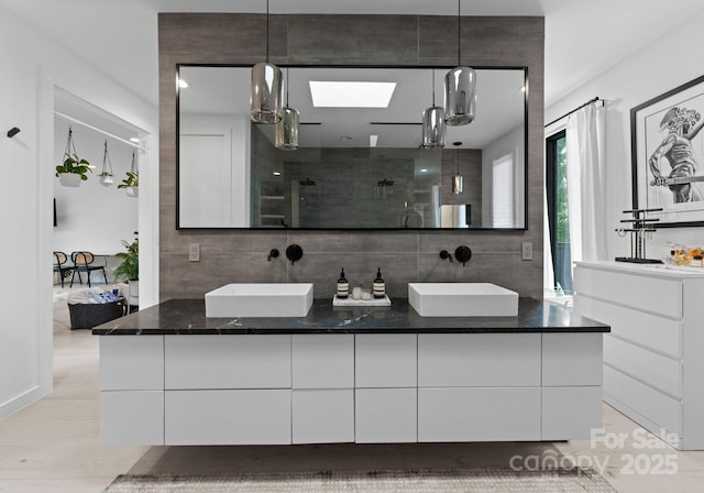 2913 Lake Ave, Charlotte, NC 28208 - bathroom with double vanity, a shower stall, and connected bathroom