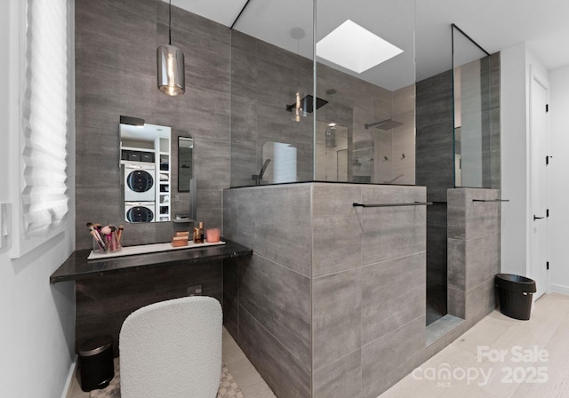 2913 Lake Ave, Charlotte, NC 28208 - bathroom featuring stacked washer / drying machine, a walk in shower, and a skylight