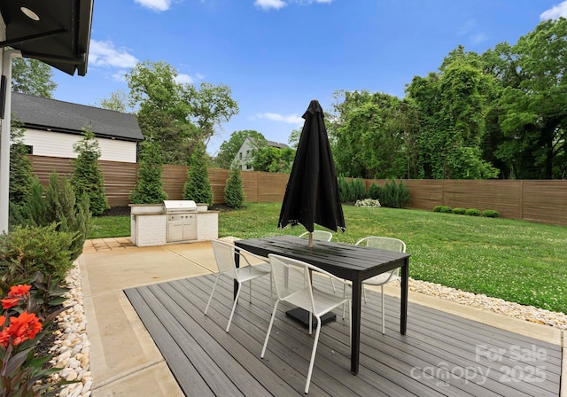 2913 Lake Ave, Charlotte, NC 28208 - wooden terrace with outdoor dining space, an outdoor kitchen, and a patio
