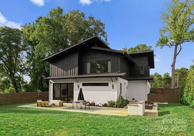2913 Lake Ave, Charlotte, NC 28208 - back of property featuring a patio, board and batten siding, and brick siding