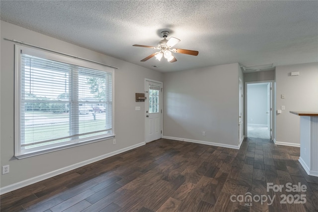 133 Pheasant Run Rd, Troutman, NC 28166 - unfurnished living room with ceiling fan, dark wood-type flooring, a textured ceiling, and baseboards