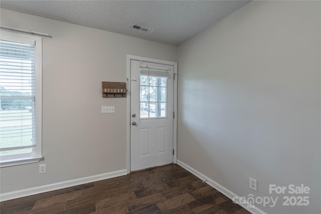 133 Pheasant Run Rd, Troutman, NC 28166 - doorway featuring plenty of natural light, baseboards, dark wood-type flooring, and a textured ceiling