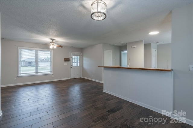 133 Pheasant Run Rd, Troutman, NC 28166 - spare room with a textured ceiling, dark wood-type flooring, a ceiling fan, and baseboards