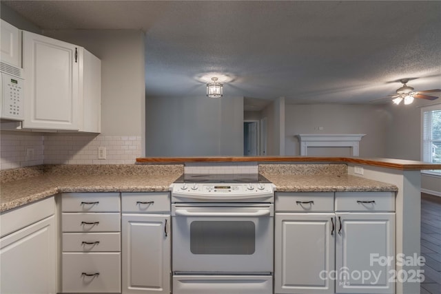 133 Pheasant Run Rd, Troutman, NC 28166 - kitchen featuring white appliances, a ceiling fan, white cabinets, tasteful backsplash, and light countertops