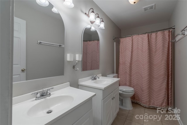 133 Pheasant Run Rd, Troutman, NC 28166 - full bath featuring two vanities, toilet, tile patterned floors, and a shower with shower curtain