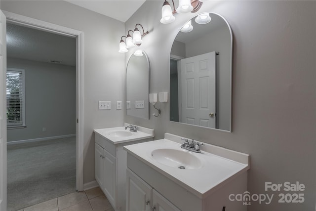 133 Pheasant Run Rd, Troutman, NC 28166 - bathroom featuring two vanities, tile patterned floors, and baseboards