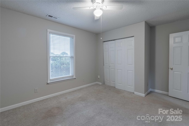133 Pheasant Run Rd, Troutman, NC 28166 - unfurnished bedroom with a textured ceiling, carpet, a closet, baseboards, and a ceiling fan
