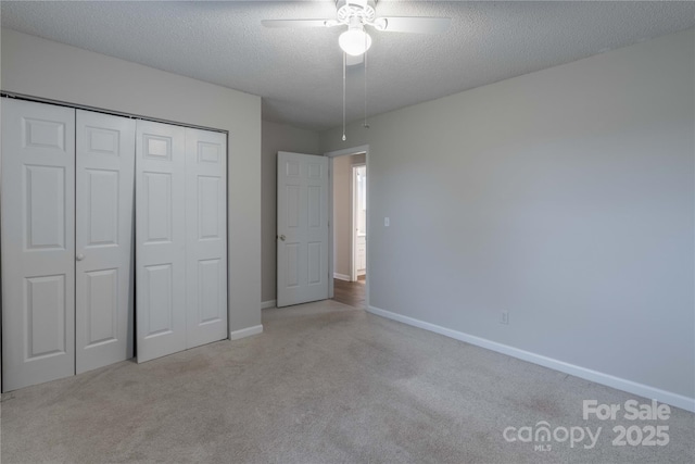 133 Pheasant Run Rd, Troutman, NC 28166 - unfurnished bedroom with carpet flooring, baseboards, a closet, a textured ceiling, and a ceiling fan