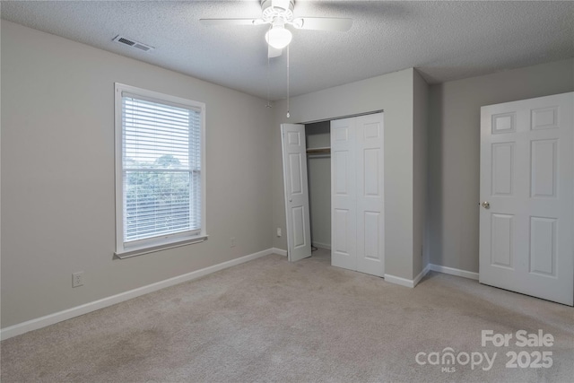 133 Pheasant Run Rd, Troutman, NC 28166 - unfurnished bedroom with a textured ceiling, light colored carpet, a closet, baseboards, and ceiling fan