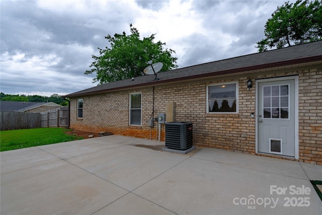 133 Pheasant Run Rd, Troutman, NC 28166 - rear view of house featuring cooling unit, brick siding, and a patio