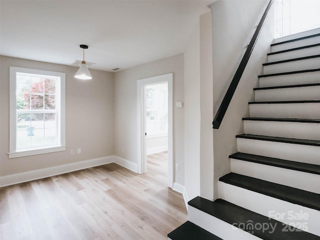 stairway featuring wood finished floors and baseboards