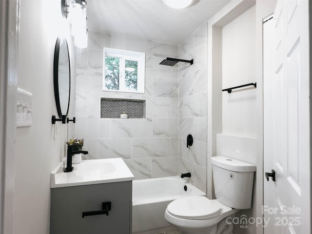 bathroom featuring toilet, vanity, and  shower combination