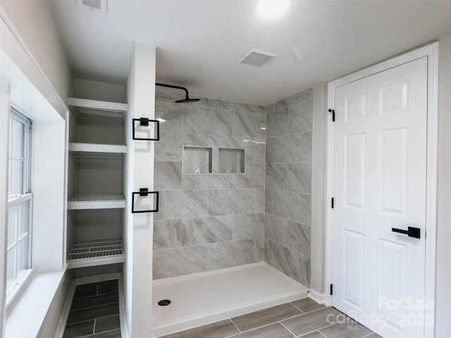 full bath with a shower stall and wood tiled floors