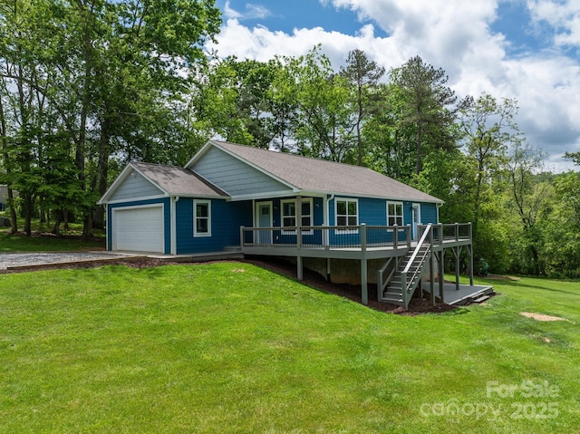 view of front of property featuring driveway, a front yard, stairway, a shingled roof, and a deck
