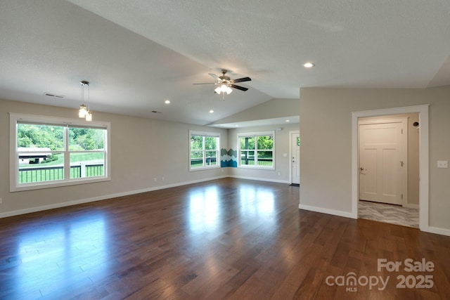 unfurnished living room featuring dark wood-style floors, ceiling fan, baseboards, vaulted ceiling, and recessed lighting