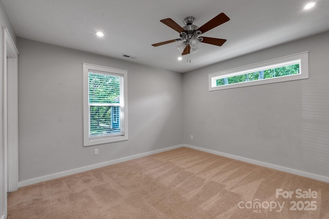spare room with light colored carpet, baseboards, ceiling fan, and recessed lighting