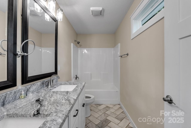 bathroom featuring toilet, vanity, bathtub / shower combination, and baseboards