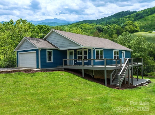 123 Dapple Rd, Candler, NC 28715 - view of front of house featuring a front yard, a mountain view, a garage, and concrete driveway