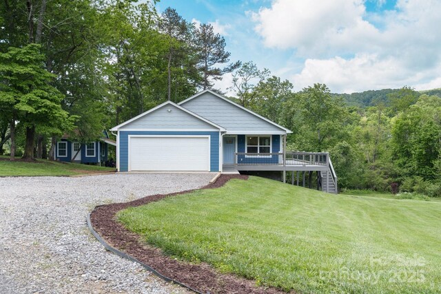 123 Dapple Rd, Candler, NC 28715 - view of front of home featuring gravel driveway, a porch, a front lawn, and an attached garage