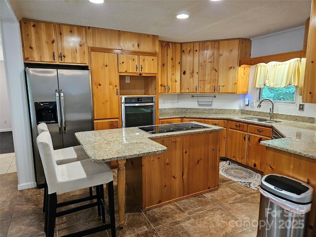 3191 Piedmont Rd, Morganton, NC 28655 - kitchen with appliances with stainless steel finishes, a sink, a kitchen island, recessed lighting, and light stone countertops