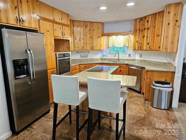 3191 Piedmont Rd, Morganton, NC 28655 - kitchen with stainless steel appliances, a sink, recessed lighting, a center island, and a breakfast bar area