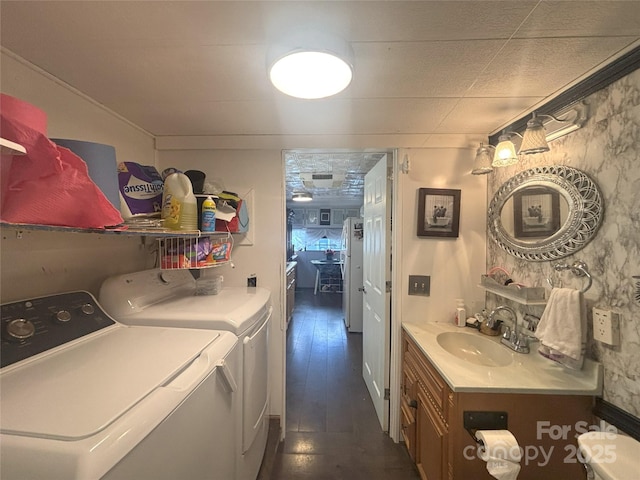 laundry area with separate washer and dryer and dark wood-style flooring