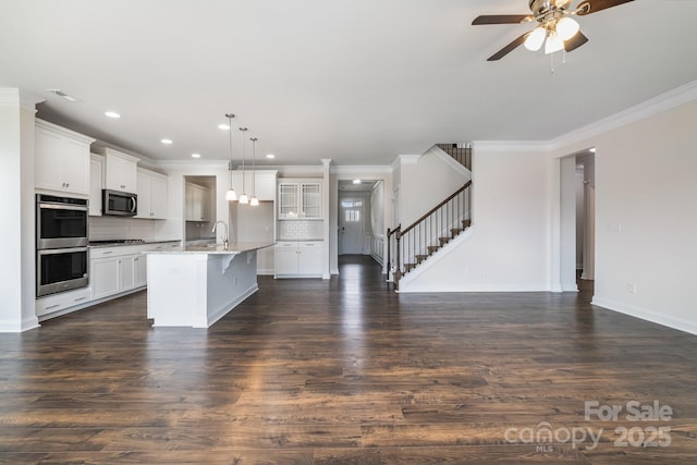 145 Yellow Birch Loop, Mooresville, NC 28117 - kitchen with stainless steel appliances, open floor plan, a ceiling fan, ornamental molding, and tasteful backsplash