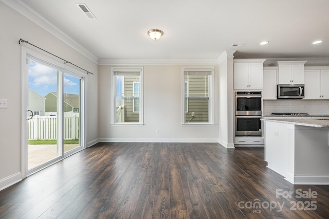 145 Yellow Birch Loop, Mooresville, NC 28117 - kitchen featuring stainless steel appliances, dark wood-type flooring, crown molding, tasteful backsplash, and white cabinets