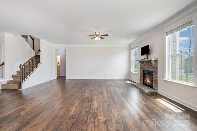 145 Yellow Birch Loop, Mooresville, NC 28117 - unfurnished living room featuring stairs, dark wood-style flooring, a fireplace, a ceiling fan, and crown molding