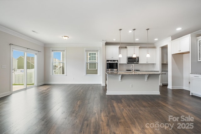 145 Yellow Birch Loop, Mooresville, NC 28117 - kitchen with stainless steel microwave, light stone countertops, tasteful backsplash, dark wood finished floors, and ornamental molding