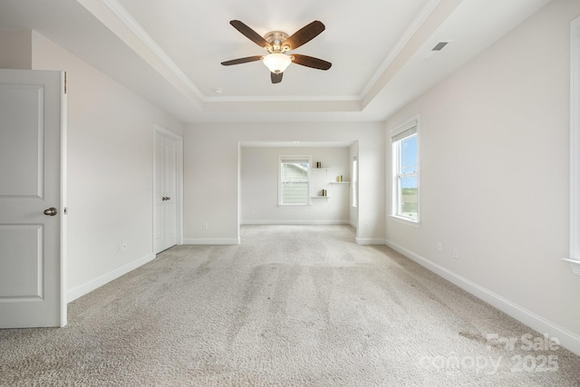 145 Yellow Birch Loop, Mooresville, NC 28117 - spare room featuring a raised ceiling, ceiling fan, light carpet, and baseboards