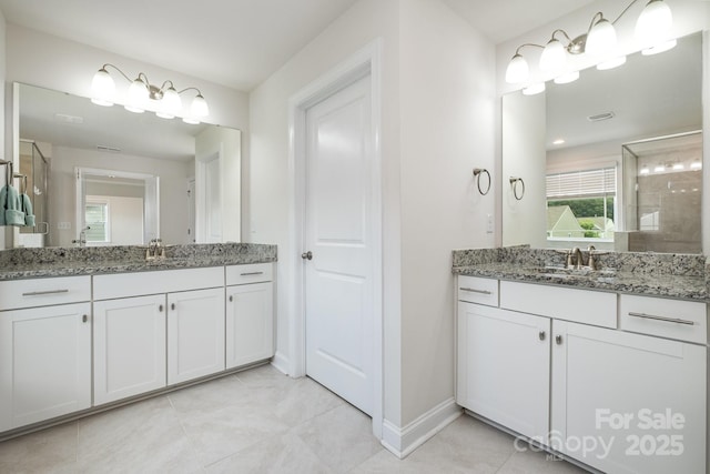145 Yellow Birch Loop, Mooresville, NC 28117 - bathroom with baseboards, a stall shower, tile patterned flooring, and two vanities
