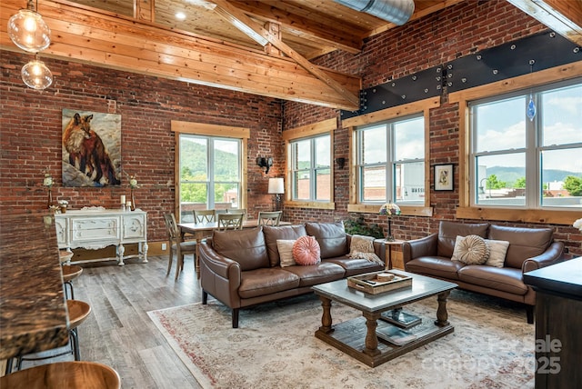 14 N Main St Unit 2, Waynesville, NC 28786 - living room with brick wall, a towering ceiling, hardwood / wood-style floors, wooden ceiling, and beamed ceiling