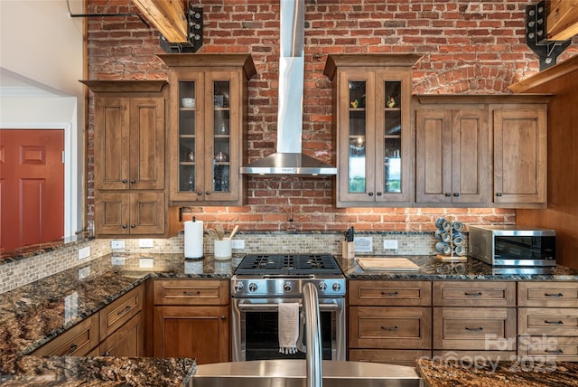 14 N Main St Unit 2, Waynesville, NC 28786 - kitchen featuring stainless steel appliances, brown cabinetry, backsplash, and glass insert cabinets