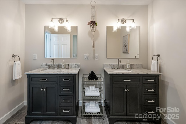 14 N Main St Unit 2, Waynesville, NC 28786 - bathroom featuring baseboards, two vanities, and wood finished floors