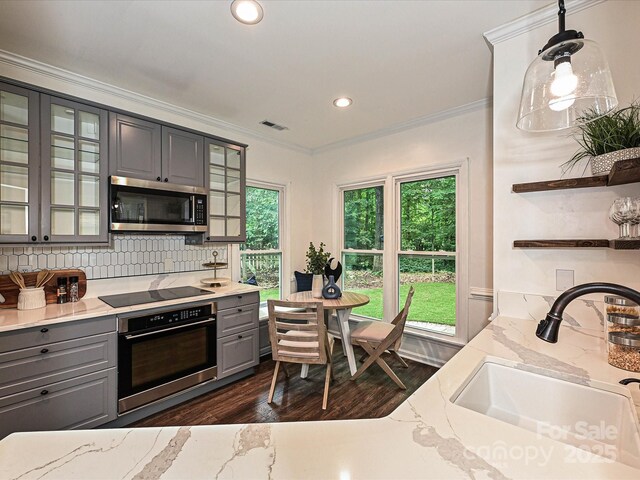 4315 Poplar Grove Dr, Charlotte, NC 28269 - kitchen featuring gray cabinetry, stainless steel appliances, a sink, dark wood-style floors, and decorative backsplash