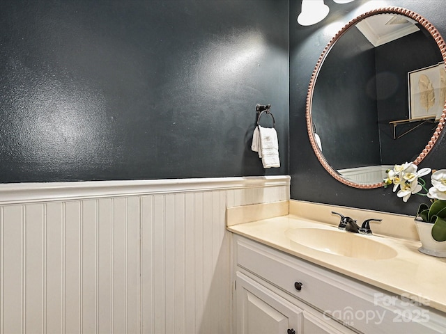 4315 Poplar Grove Dr, Charlotte, NC 28269 - bathroom with a wainscoted wall, vanity, and crown molding