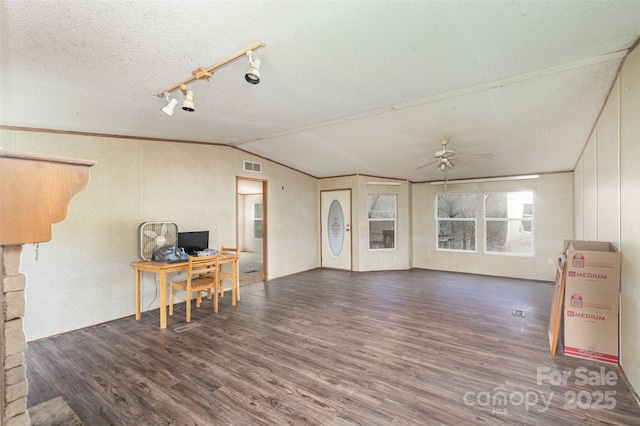living area featuring wood finished floors, ceiling fan, lofted ceiling, an office area, and a textured ceiling