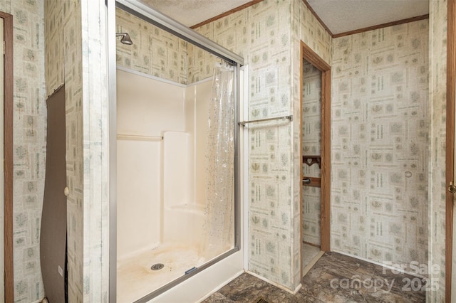 bathroom with wallpapered walls, a shower stall, ornamental molding, and a textured ceiling