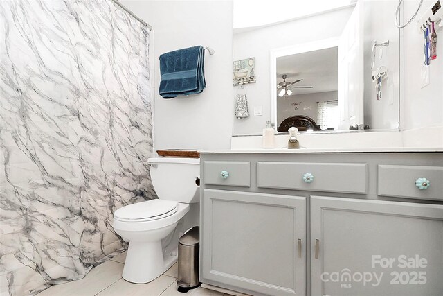 full bath with toilet, tile patterned floors, vanity, ceiling fan, and a shower with shower curtain