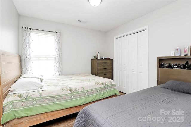 bedroom featuring a closet and wood finished floors