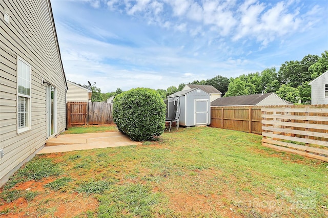 view of yard with a storage shed and an outbuilding