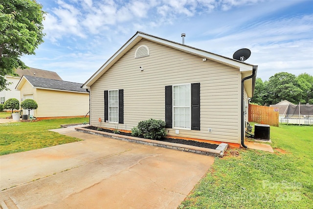 view of front of property with a trampoline and central AC unit